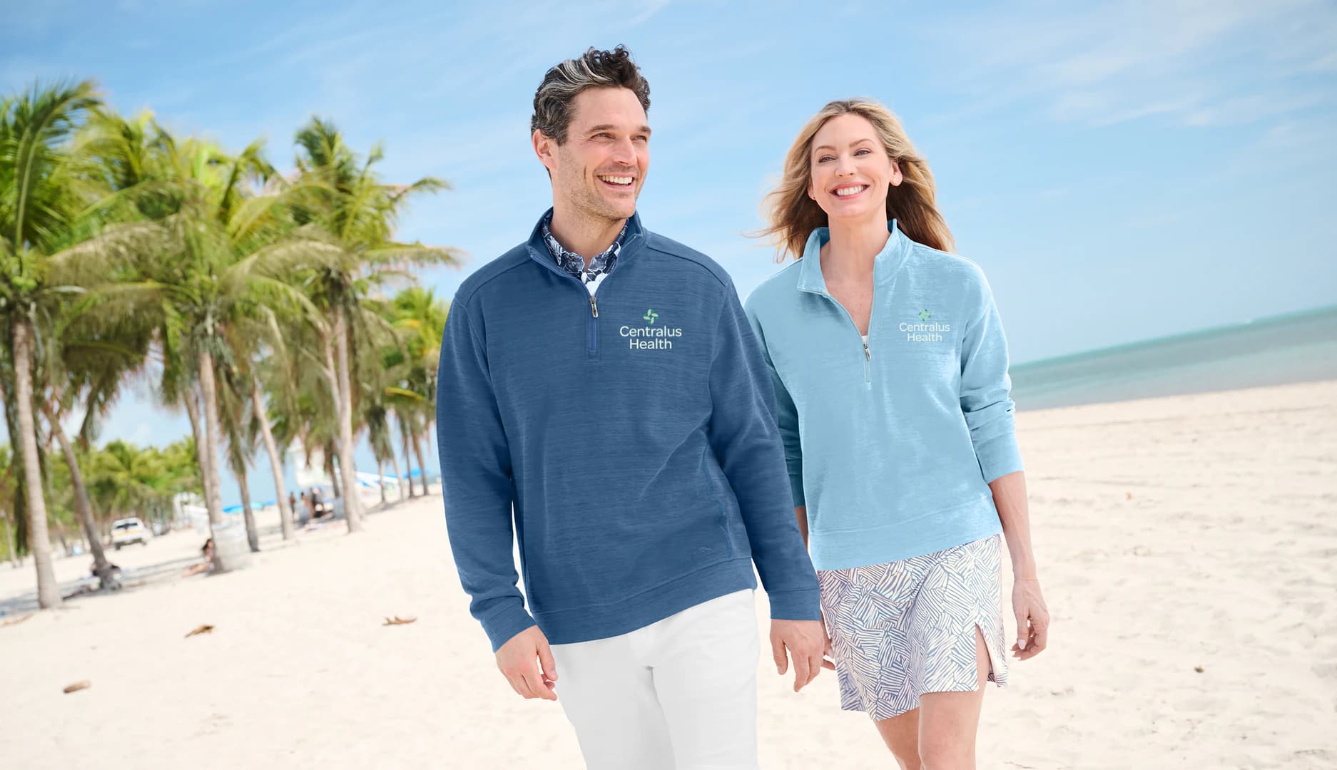 Two colleagues on a beach in Centralus Health quarter-zips